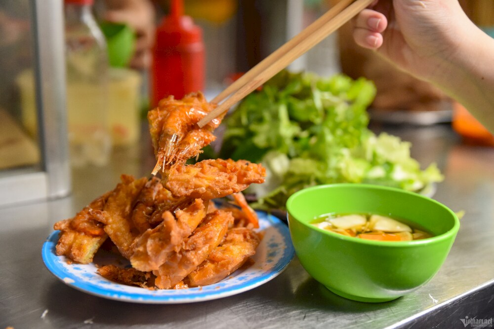 Mrs. Am's shrimp cakes are crispy and golden brown, eaten with sweet and sour dipping sauce